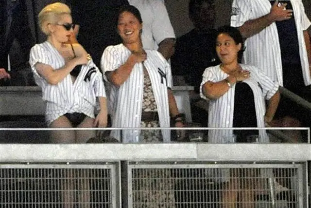 Lady Gaga adjusts her jersey